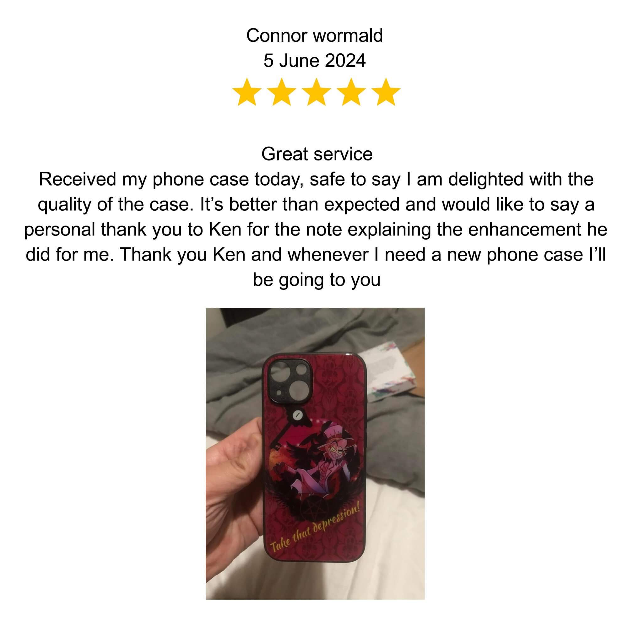 A hand holding a smartphone with a floral case.