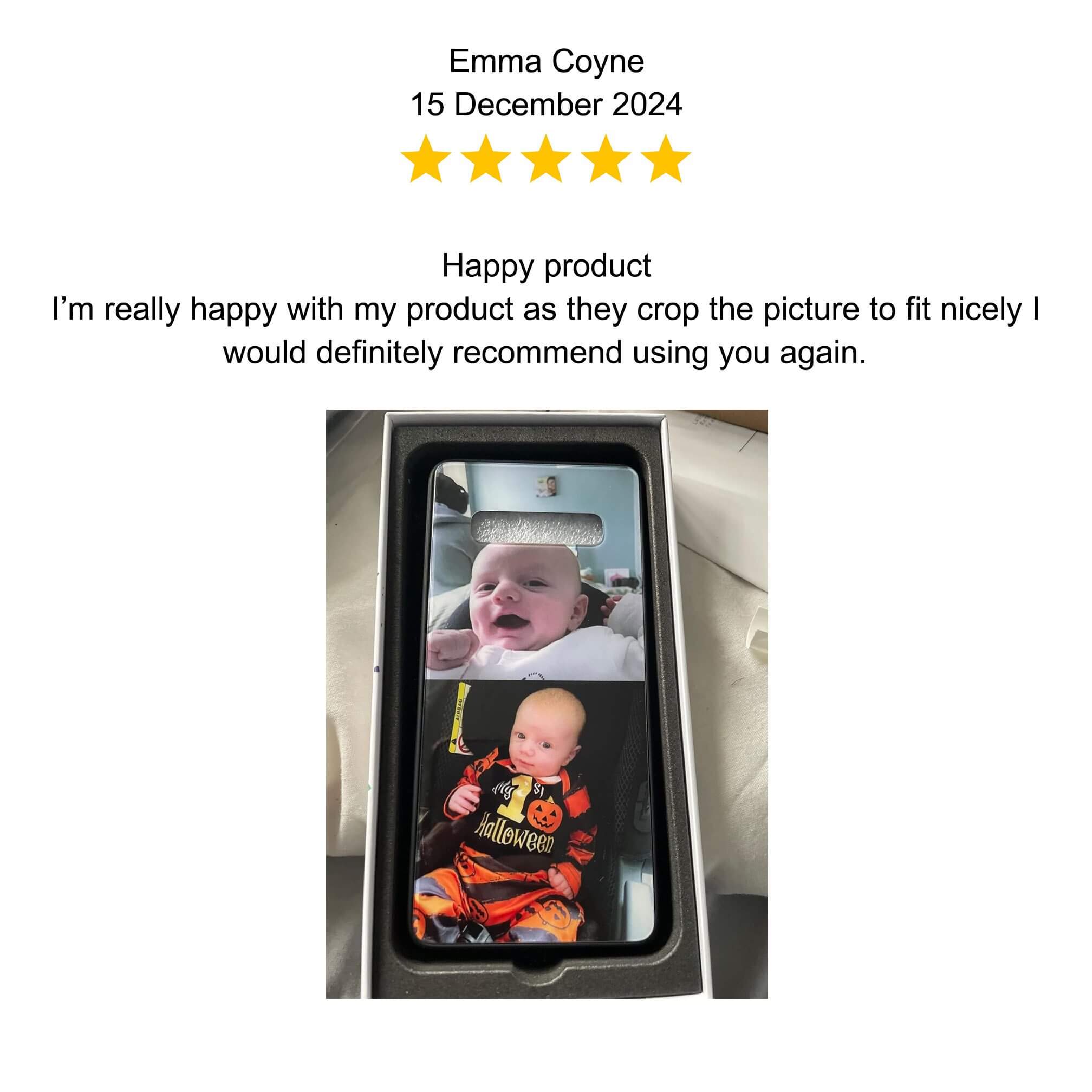 A baby happily sitting in a toy car indoors.